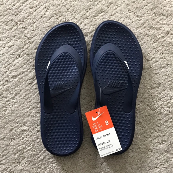 navy blue nike flip flops